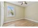 This bedroom has a large window and a ceiling fan at 9709 Bay Colony Dr, Riverview, FL 33578