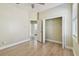 Bedroom with wood-look floors leads to a closet and ensuite bathroom at 9709 Bay Colony Dr, Riverview, FL 33578