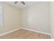 Bright bedroom featuring light wood-look floors, a ceiling fan, and neutral wall color at 9709 Bay Colony Dr, Riverview, FL 33578