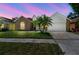 Charming single-Gathering home with a brick facade, two-car garage, well-manicured lawn, and palm tree at 9709 Bay Colony Dr, Riverview, FL 33578