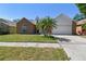 Charming single-Gathering home with a brick facade, two-car garage, well-manicured lawn, and palm tree at 9709 Bay Colony Dr, Riverview, FL 33578
