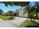 Charming single-Gathering home with lush landscaping, a brick facade, and a two-car garage at 9709 Bay Colony Dr, Riverview, FL 33578