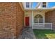 Inviting front entrance with a red door, brick accents, and a stone pathway leading to the entrance at 9709 Bay Colony Dr, Riverview, FL 33578