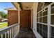 Charming covered front porch with brick accents and a stone pathway leading to the entrance at 9709 Bay Colony Dr, Riverview, FL 33578