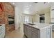 Spacious kitchen with stainless steel appliances, gray cabinetry, large island, and an open floor plan at 9709 Bay Colony Dr, Riverview, FL 33578