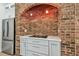 Updated kitchen with stainless steel appliances, brick oven nook, smooth cooktop, and gray cabinetry at 9709 Bay Colony Dr, Riverview, FL 33578
