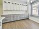 Kitchenette with built-in cabinets, quartz countertops, and a large window for natural light at 9709 Bay Colony Dr, Riverview, FL 33578