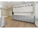 Bright kitchenette featuring stylish cabinetry, generous counter space, and sleek wood-look flooring at 9709 Bay Colony Dr, Riverview, FL 33578