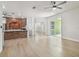 Open-concept living area with hardwood floors and brick accent wall at 9709 Bay Colony Dr, Riverview, FL 33578