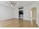 Bright living room with hardwood floors, TV nook, and modern ceiling fan at 9709 Bay Colony Dr, Riverview, FL 33578