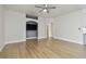 Bright living room with hardwood floors, archway, and a TV nook at 9709 Bay Colony Dr, Riverview, FL 33578