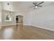 Bright living room featuring hardwood floors, archways and a modern ceiling fan at 9709 Bay Colony Dr, Riverview, FL 33578