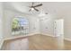 Bright living room featuring hardwood floors, large window and modern ceiling fan at 9709 Bay Colony Dr, Riverview, FL 33578