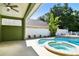 Backyard pool and spa with a covered patio area, perfect for outdoor entertaining at 9709 Bay Colony Dr, Riverview, FL 33578