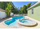 View of the uniquely shaped outdoor pool and spa at 9709 Bay Colony Dr, Riverview, FL 33578