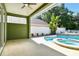 Outdoor covered patio featuring a ceiling fan, pool, and spa at 9709 Bay Colony Dr, Riverview, FL 33578
