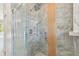 Contemporary shower with glass enclosure and stylish marble-look tile surround at 9709 Bay Colony Dr, Riverview, FL 33578