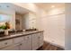 Bathroom with double vanity, quartz countertop, and walk-in shower offers a sleek, modern design at 9795 Crescent Ray Dr, Wesley Chapel, FL 33545
