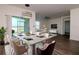 Open dining area with modern chandelier, leading to the living room and featuring sliding glass doors at 9795 Crescent Ray Dr, Wesley Chapel, FL 33545