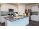 Bright kitchen featuring white cabinets, stainless steel appliances, gray countertops, and center island at 9795 Crescent Ray Dr, Wesley Chapel, FL 33545