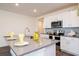 Modern kitchen boasts white cabinets, stainless steel appliances, gray countertops, and stylish backsplash at 9795 Crescent Ray Dr, Wesley Chapel, FL 33545