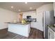 Bright, spacious kitchen features modern white cabinetry, stainless steel appliances, and a center island at 9795 Crescent Ray Dr, Wesley Chapel, FL 33545