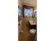A neutral toned bathroom featuring tile flooring, a sink with vanity, and standard toilet at 9805 110Th Ln, Seminole, FL 33772