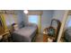 Bedroom with blue walls and a single bed near a vintage wood dresser at 9805 110Th Ln, Seminole, FL 33772
