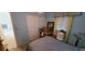 Bedroom with a bed, storage shelves and boxes at 9805 110Th Ln, Seminole, FL 33772
