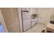 Kitchen features all white appliances and tile flooring at 9805 110Th Ln, Seminole, FL 33772