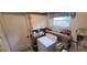 Functional laundry area with washer, overhead cabinets, and natural light from the window at 9805 110Th Ln, Seminole, FL 33772