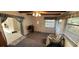 Cozy living room featuring natural light, neutral carpeting, and a front door entrance at 9805 110Th Ln, Seminole, FL 33772