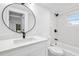 Clean bathroom featuring an updated vanity, a mirror, shower and toilet at 9831 Scenic Dr, Port Richey, FL 34668