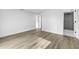 Spacious room with wood floors, featuring an entryway to the updated bathroom at 9831 Scenic Dr, Port Richey, FL 34668