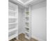 Walk-in closet with shelving for ample storage and organization at 9831 Scenic Dr, Port Richey, FL 34668