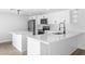 Bright kitchen with white cabinetry, stainless steel appliances, and quartz countertops at 9831 Scenic Dr, Port Richey, FL 34668