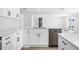 Clean, bright kitchen featuring white cabinets, modern hardware and stainless steel appliances at 9831 Scenic Dr, Port Richey, FL 34668