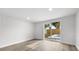 Spacious living room featuring wood floors, and sliding glass door access to the backyard at 9831 Scenic Dr, Port Richey, FL 34668