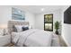 Staged main bedroom featuring neutral walls, a large window and decor at 9831 Scenic Dr, Port Richey, FL 34668
