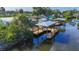 Aerial view of a home featuring a private dock on the canal, highlighting its waterfront location and accessibility at 9929 Bay Dr, Gibsonton, FL 33534