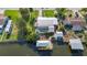 Aerial view of the home with metal roof, pool, dock, lush landscaping, and charming backyard at 9929 Bay Dr, Gibsonton, FL 33534