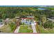 Aerial view highlighting this beautifully landscaped single-Gathering home with fenced in yard, mature landscaping, and dock at 9929 Bay Dr, Gibsonton, FL 33534