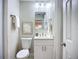 Bathroom featuring a new white vanity with modern fixtures and a framed mirror at 9929 Bay Dr, Gibsonton, FL 33534