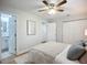 Bedroom with ceiling fan, closet, light-tone walls, and door to the bathroom at 9929 Bay Dr, Gibsonton, FL 33534