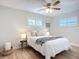 Cozy bedroom features two windows, a ceiling fan, hardwood flooring, and neutral décor at 9929 Bay Dr, Gibsonton, FL 33534