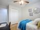 Bedroom featuring bright white trim and walls, ceiling fan and a closet at 9929 Bay Dr, Gibsonton, FL 33534