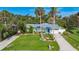 Beautiful front yard with lush landscaping and a well-maintained lawn, enhancing the home's curb appeal at 9929 Bay Dr, Gibsonton, FL 33534
