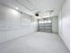 Spacious garage with painted walls and floor, window, and functional door at 9929 Bay Dr, Gibsonton, FL 33534