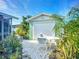 Detached garage with lush landscaping, complemented by a seating area for relaxation and enjoying the outdoors at 9929 Bay Dr, Gibsonton, FL 33534