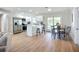 Spacious kitchen featuring stainless steel appliances, white cabinetry, an island with seating, and adjacent dining area at 9929 Bay Dr, Gibsonton, FL 33534